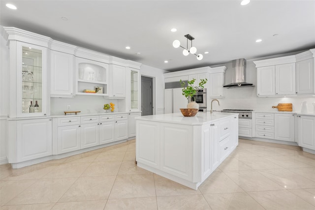 9 Oak Ridge Ct, West Harrison, NY 10604 - kitchen with wall chimney exhaust hood, appliances with stainless steel finishes, light countertops, a sink, and white cabinetry