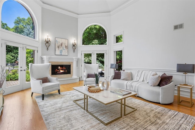 9 Oak Ridge Ct, West Harrison, NY 10604 - living room featuring a high ceiling, a glass covered fireplace, ornamental molding, and wood finished floors