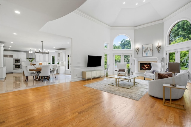 9 Oak Ridge Ct, West Harrison, NY 10604 - living area featuring a high ceiling, a warm lit fireplace, plenty of natural light, recessed lighting, and light wood-style floors