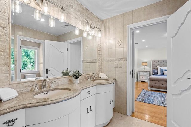 9 Oak Ridge Ct, West Harrison, NY 10604 - ensuite bathroom featuring double vanity, tile walls, and tile patterned flooring