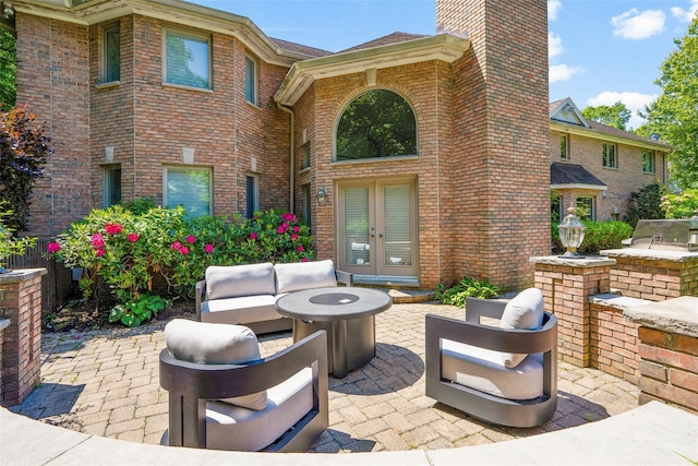 9 Oak Ridge Ct, West Harrison, NY 10604 - view of patio featuring french doors, area for grilling, and an outdoor living space with a fire pit