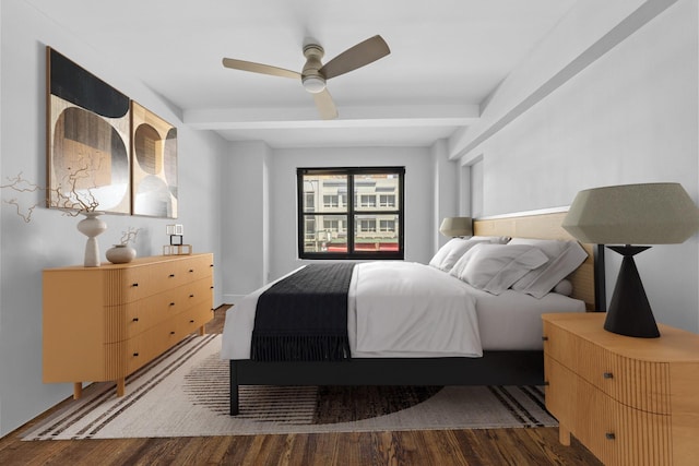 bedroom with a ceiling fan, beam ceiling, and wood finished floors