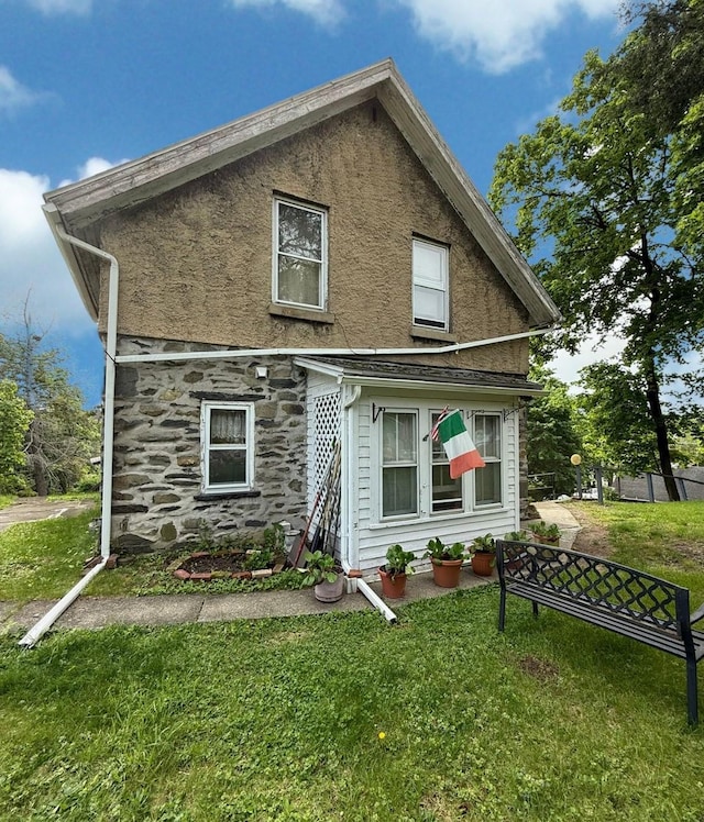 17 Springside Ave, Poughkeepsie, NY 12603 - back of house featuring stone siding, a lawn, and stucco siding