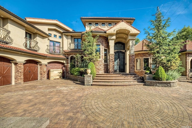 959 S End Rd, Woodmere, NY 11598 - mediterranean / spanish house with a balcony, stucco siding, a tiled roof, and stone siding
