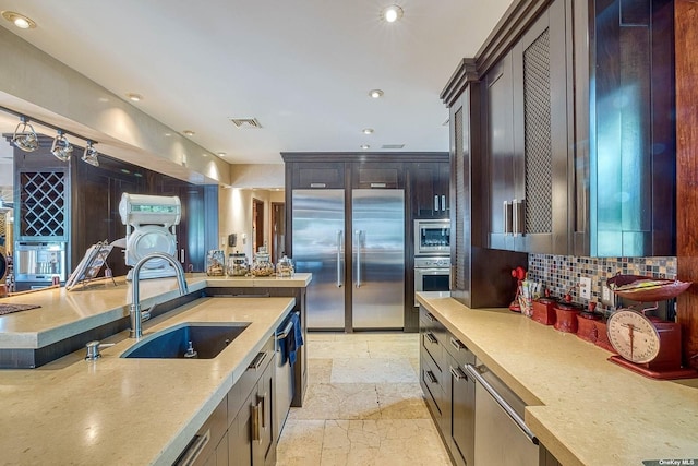 959 S End Rd, Woodmere, NY 11598 - kitchen featuring built in appliances, a sink, decorative backsplash, light countertops, and recessed lighting