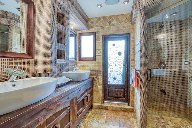 959 S End Rd, Woodmere, NY 11598 - bathroom featuring a sink, tile walls, a stall shower, and stone finish floors