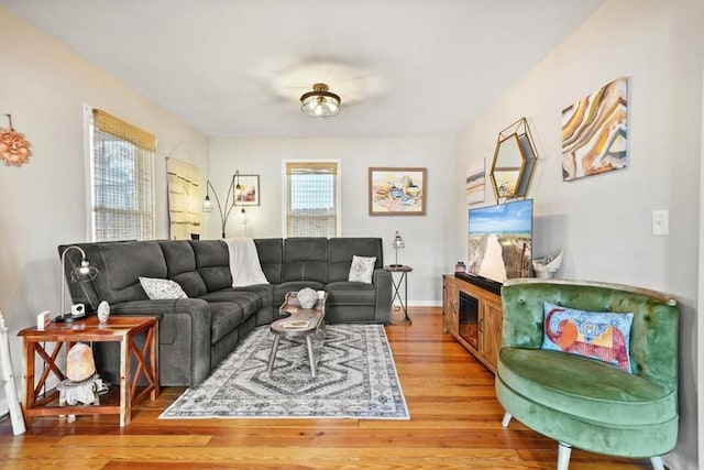 living area with baseboards and light wood finished floors