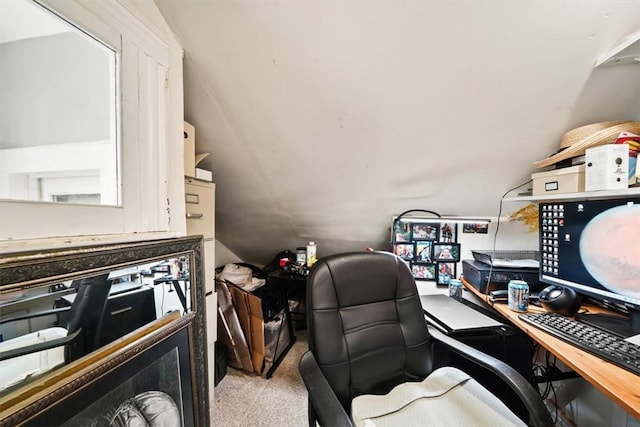 carpeted home office with lofted ceiling