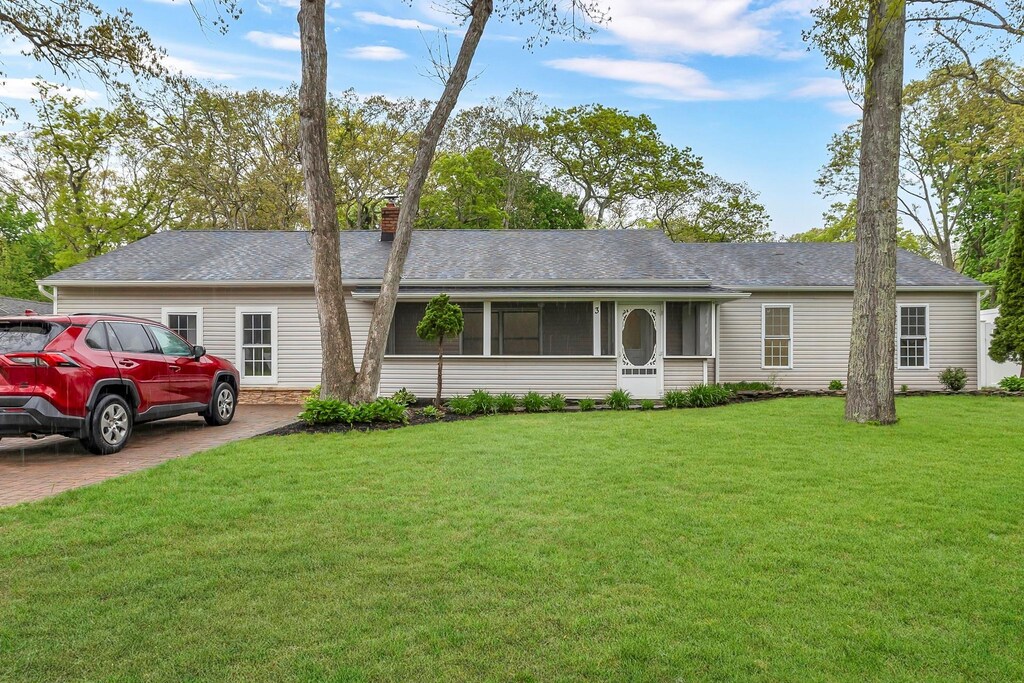 3 Russet Ln, Lake Grove, NY 11755 - single story home featuring driveway, a front lawn, a chimney, a sunroom, and a shingled roof