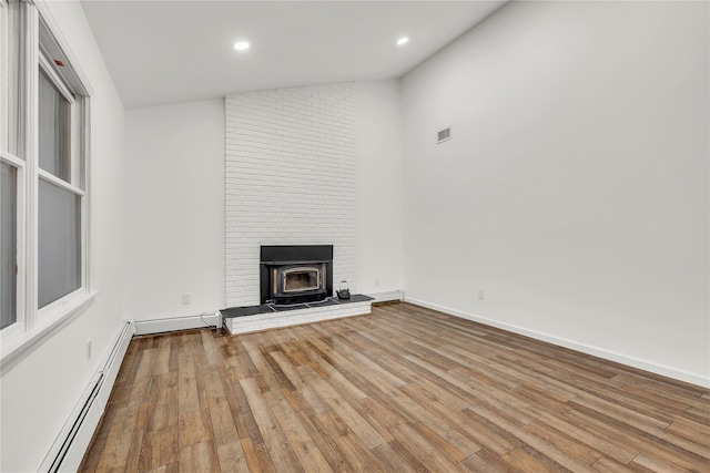 3 Russet Ln, Lake Grove, NY 11755 - unfurnished living room featuring a baseboard radiator, recessed lighting, visible vents, and wood finished floors