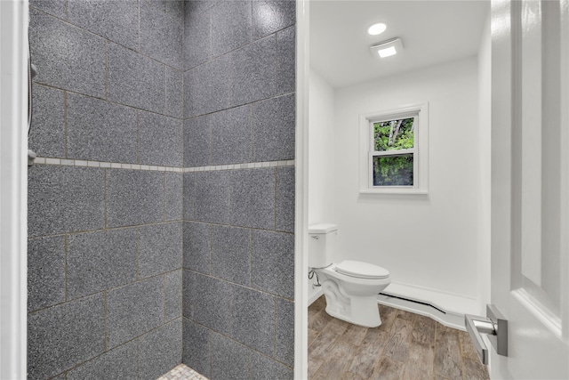 3 Russet Ln, Lake Grove, NY 11755 - bathroom with toilet, a tile shower, and wood finished floors