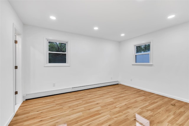 3 Russet Ln, Lake Grove, NY 11755 - unfurnished room with a baseboard radiator, light wood-type flooring, and plenty of natural light