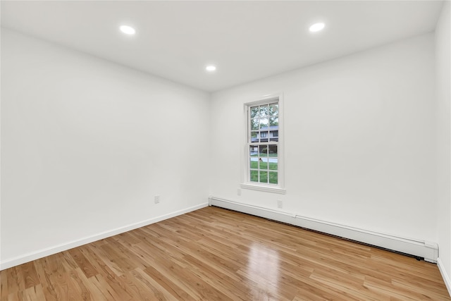 3 Russet Ln, Lake Grove, NY 11755 - empty room with baseboards, baseboard heating, and light wood-type flooring
