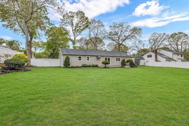 3 Russet Ln, Lake Grove, NY 11755 - back of property with a yard, a fenced backyard, and a gate