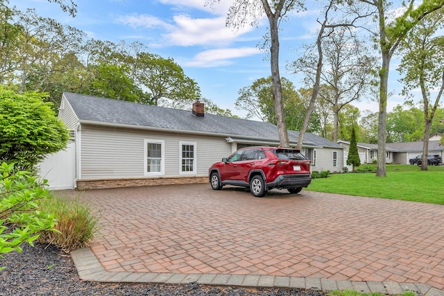 3 Russet Ln, Lake Grove, NY 11755 - view of front of home with a chimney, stone siding, a front lawn, and decorative driveway