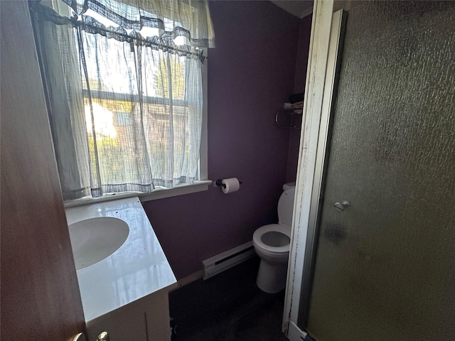 full bath with a baseboard radiator, vanity, toilet, and a stall shower