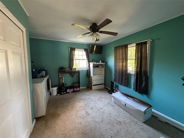 carpeted bedroom with separate washer and dryer and a ceiling fan