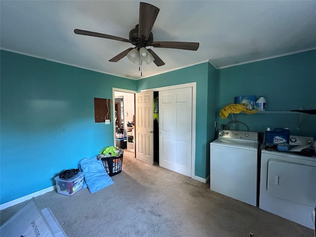 laundry area featuring washing machine and dryer, a ceiling fan, ornamental molding, carpet, and baseboards