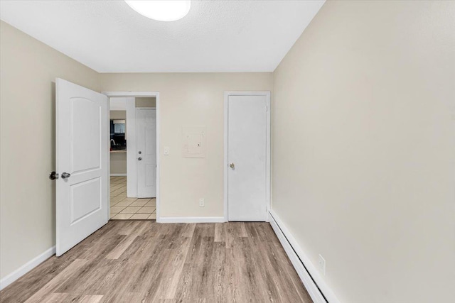 unfurnished bedroom featuring baseboards and light wood-style flooring