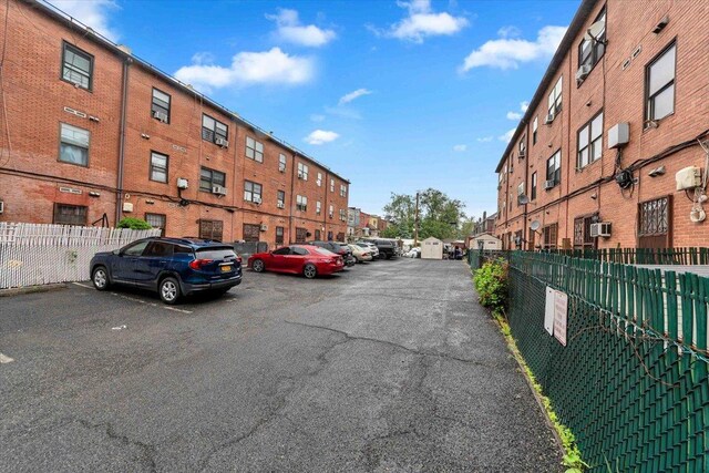 uncovered parking lot featuring fence