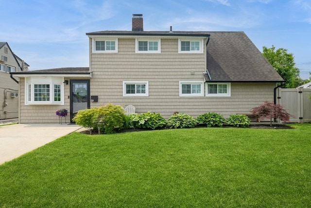 59 Springtime Ln S, Levittown, NY 11756 - back of property featuring a chimney and roof with shingles