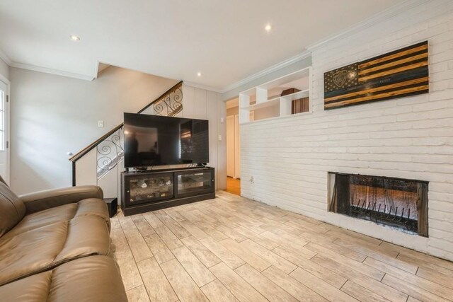 59 Springtime Ln S, Levittown, NY 11756 - living area featuring ornamental molding, wood finished floors, and a fireplace
