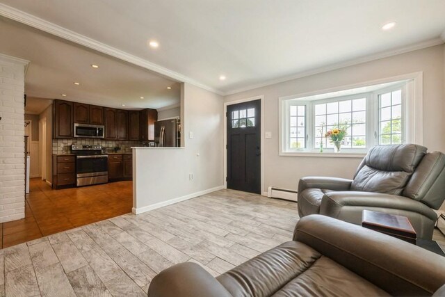 59 Springtime Ln S, Levittown, NY 11756 - living room with baseboard heating, ornamental molding, light wood-type flooring, recessed lighting, and baseboards