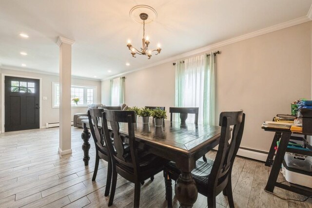 59 Springtime Ln S, Levittown, NY 11756 - dining room featuring crown molding, light wood-style flooring, a chandelier, ornate columns, and a baseboard heating unit
