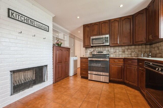 59 Springtime Ln S, Levittown, NY 11756 - kitchen featuring appliances with stainless steel finishes, light tile patterned floors, decorative backsplash, a sink, and crown molding