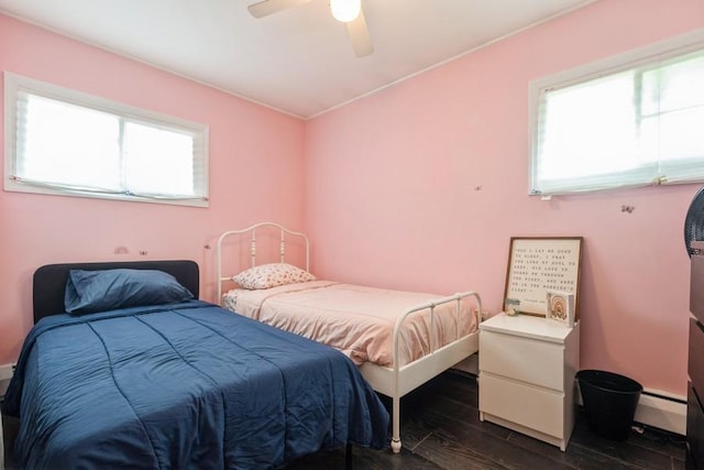 59 Springtime Ln S, Levittown, NY 11756 - bedroom featuring dark wood-style floors, ceiling fan, baseboards, and baseboard heating