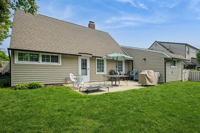 59 Springtime Ln S, Levittown, NY 11756 - back of property featuring a chimney, a patio area, and roof with shingles