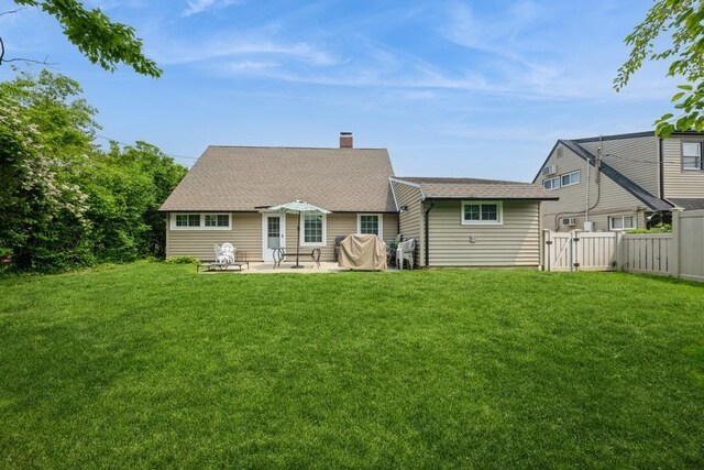 59 Springtime Ln S, Levittown, NY 11756 - rear view of property featuring a patio, a chimney, a gate, and a shingled roof