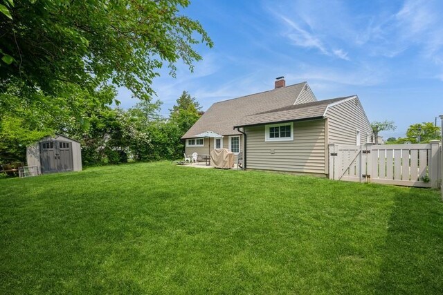 59 Springtime Ln S, Levittown, NY 11756 - rear view of property featuring a gate, a chimney, a patio area, and roof with shingles