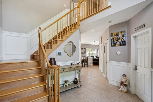 4 Millennium Ct, Bohemia, NY 11716 - stairs with a decorative wall, a wainscoted wall, and tile patterned flooring