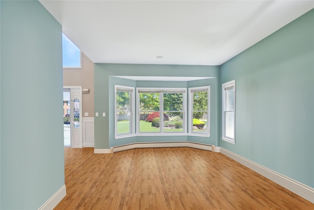 4 Millennium Ct, Bohemia, NY 11716 - unfurnished room with light wood-type flooring, a baseboard radiator, and baseboards