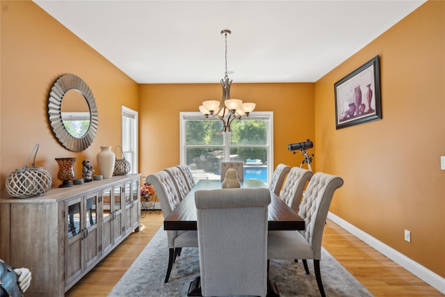4 Millennium Ct, Bohemia, NY 11716 - dining space with a chandelier, light wood-style flooring, and baseboards