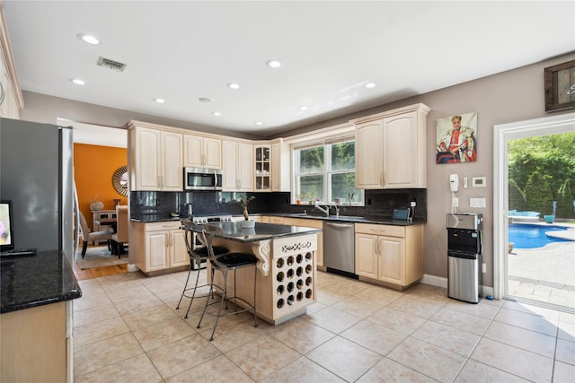 4 Millennium Ct, Bohemia, NY 11716 - kitchen featuring stainless steel appliances, backsplash, plenty of natural light, recessed lighting, and light tile patterned floors