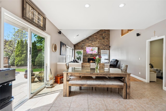 4 Millennium Ct, Bohemia, NY 11716 - dining room with a stone fireplace, light tile patterned flooring, recessed lighting, baseboards, and high vaulted ceiling