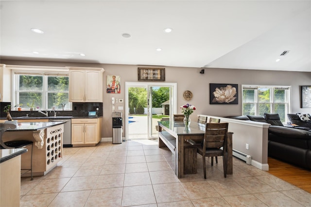4 Millennium Ct, Bohemia, NY 11716 - kitchen featuring stainless steel dishwasher, a baseboard heating unit, dark countertops, open floor plan, and tasteful backsplash
