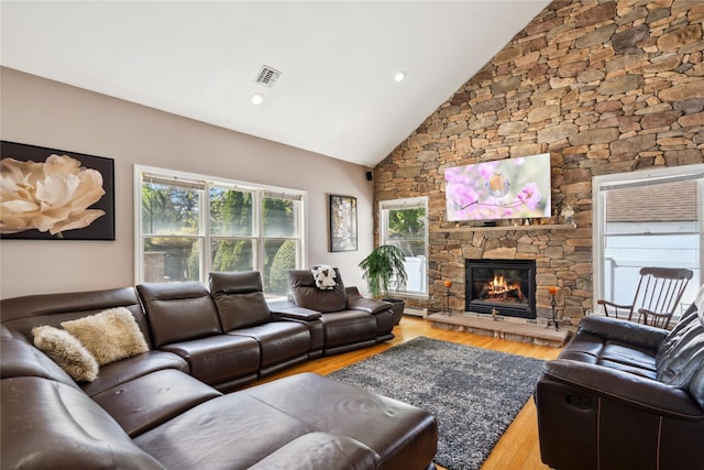 4 Millennium Ct, Bohemia, NY 11716 - living room featuring a stone fireplace, wood finished floors, and high vaulted ceiling