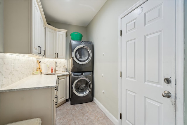 4 Millennium Ct, Bohemia, NY 11716 - laundry area featuring stacked washer and clothes dryer, cabinet space, baseboards, and light tile patterned flooring