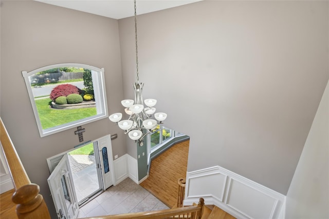 4 Millennium Ct, Bohemia, NY 11716 - entrance foyer with a chandelier, plenty of natural light, a towering ceiling, light tile patterned floors, and stairway