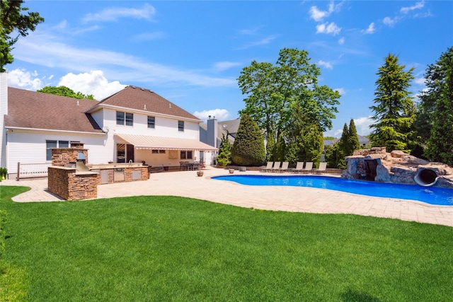 4 Millennium Ct, Bohemia, NY 11716 - swimming pool with an outdoor kitchen, a yard, and a patio