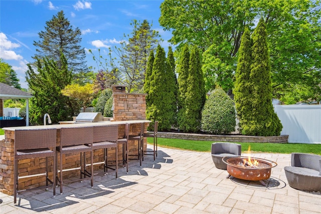 4 Millennium Ct, Bohemia, NY 11716 - view of patio featuring an outdoor fire pit and an outdoor kitchen