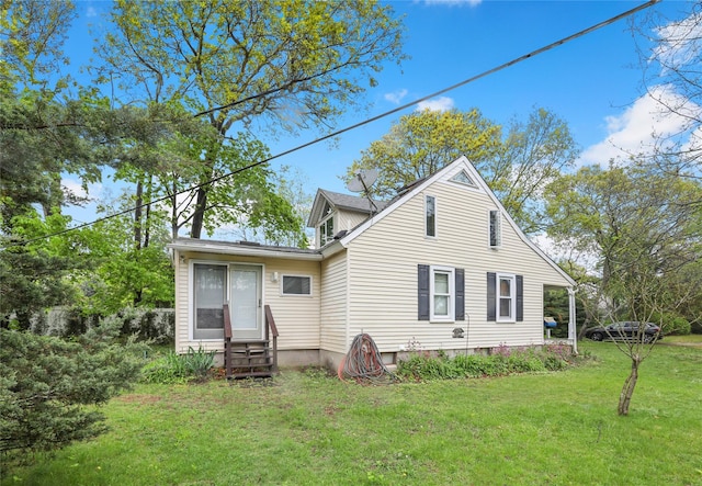 rear view of property with a yard and entry steps