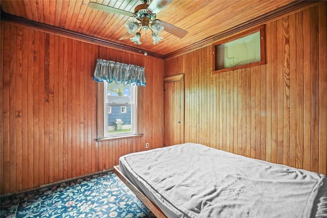 bedroom with ornamental molding, wood walls, and ceiling fan