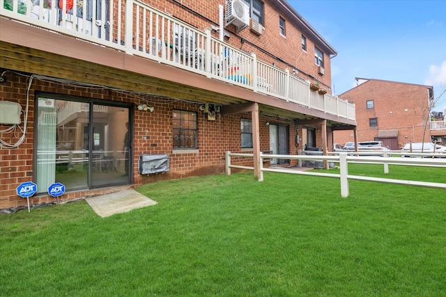 2-20 Capstan Ct Unit 102B, College Point, NY 11356 - back of property featuring brick siding, a lawn, and a wooden deck