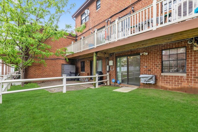 2-20 Capstan Ct Unit 102B, College Point, NY 11356 - rear view of property with brick siding and a lawn