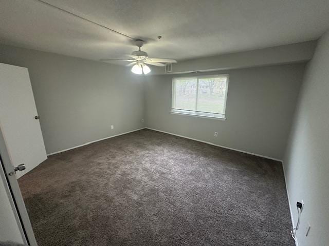 unfurnished bedroom featuring dark colored carpet, baseboards, a ceiling fan, and visible vents