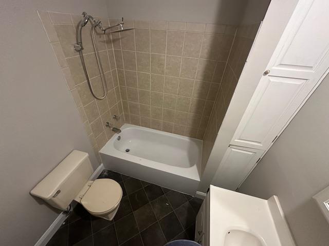 full bath featuring toilet, tile patterned flooring, and shower / bathtub combination